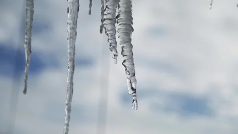 Ice icicles on the window against the background of the winter sky and the city. Stock Footage 308434382