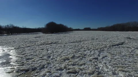 Ice Jam aerial view from low angle as camera moves down river over the ice Stock Footage 60037945