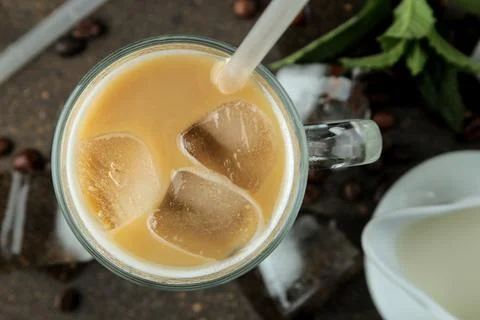 Ice latte or Iced coffee with milk and ice cubes in a glass beaker against a Stock Photos