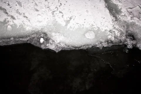 Ice layer covering the surface of dark water Stock Photos