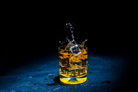 Ice with liquid splashing. Stock Photos