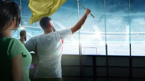 On ice low-angle view of a dramatic hockey arena full of fans in the stands w Stock Illustration