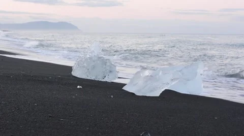 Ice lying on the black sand beach near ice lagoon, Iceland Stock Footage 40875417