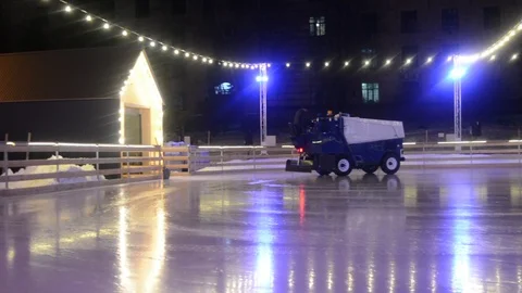 Ice machine on the ice rink in the city center, after skating with smooth ice Stock Footage 101303736