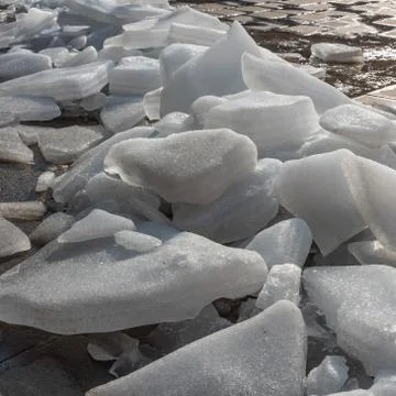 Ice melts on the ground under the warm morning sun Stock Photos