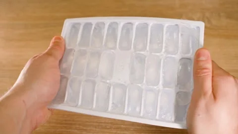 Ice mold being bent to make ice, close-up Stock Footage 324698138