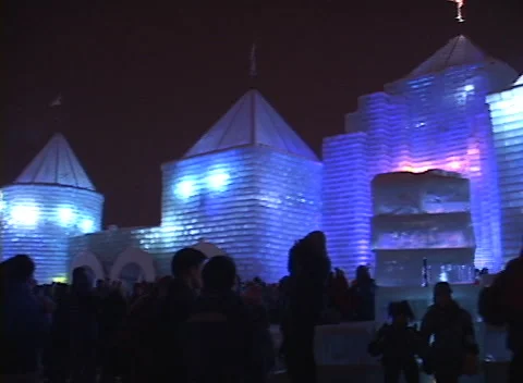 Ice Palace lights 5, boy in ice chair feels the music, ice block castle const. Stock Footage 296612643
