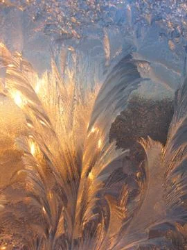 Ice pattern and sunlight on winter glass 스톡 사진