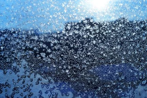 Ice pattern and sunlight on winter glass Stock Photos