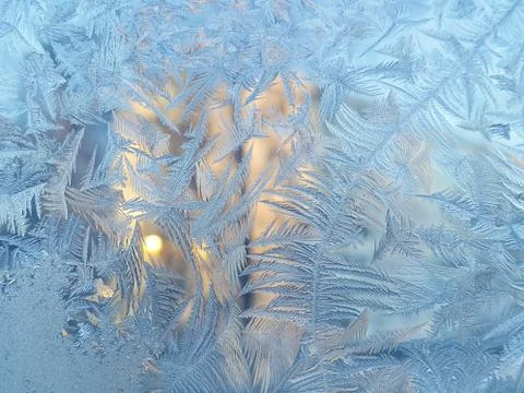 Ice pattern and sunlight on winter glass Stock Photos