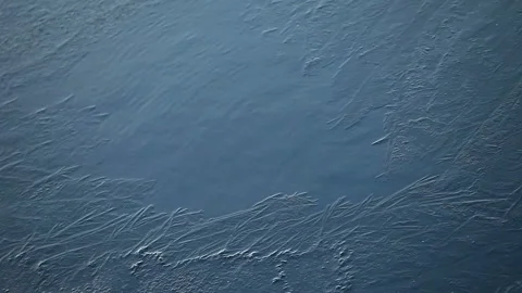 Ice pattern on blue water Stock Footage 148040437