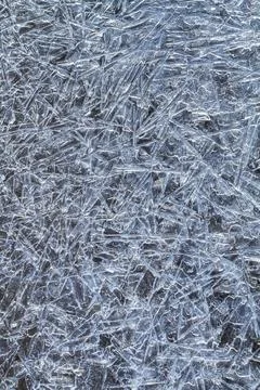 Ice pattern consisting of frozen ice needles on a dark background Stock Photos