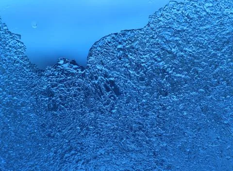Ice pattern on glass, close-up natural blue texture Stock Photos