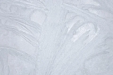 Ice patterns froze on the window. Clean blue background. beautiful texture of Stock Photos