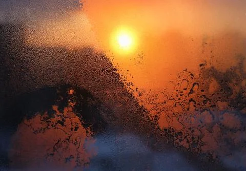 Ice patterns, water drops and sunlight on a winter window glasss Stock Photos