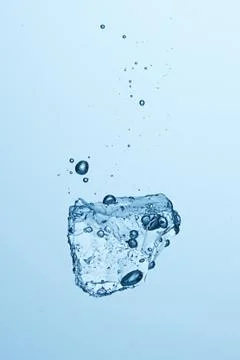 Ice piece falling in the water Stock Photos