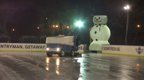 Ice polish machine, outdoor ice skating rink, machine cleaning the rink Stock Footage 33705377
