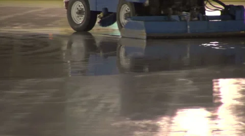 Ice polish machine, outdoor ice skating rink, machine cleaning the rink Stock Footage 33705411