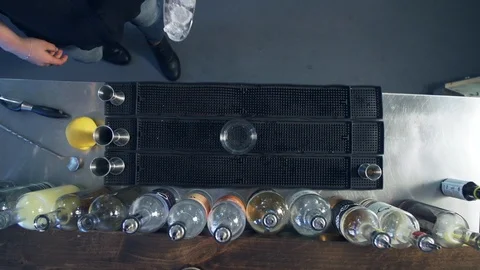 Ice poured into empty highball cocktail glass on bar mat with metal scooper Stock Footage 87267202