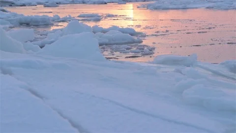 Ice reflect light of evening sunset in the middle of floes. Tracking shot Stock Footage 74991639