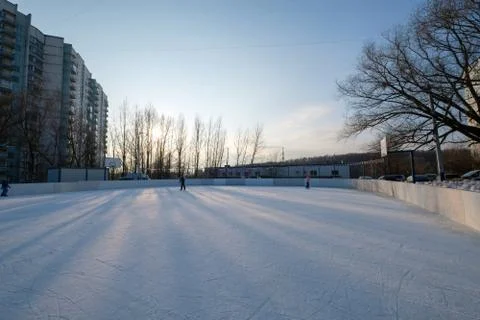Ice ring with artificial ice in yard in city suburb among tall buildings on.. Stock Photos