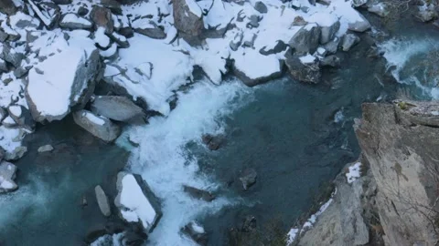 Ice River flowing trough mountains with Snow, Drone View, 4k Stock Footage 231610341