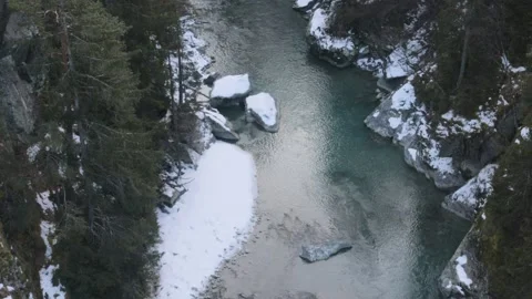 Ice River flowing trough mountains with Snow, Drone View, 4k Stock Footage 231610395