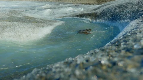 Ice River flows down Glacier 2 Stock Footage 74870759