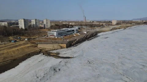 Ice on the River next to the River Station in City, Mountains Ridge, Aerial view Stock Footage 194336706