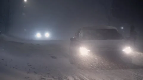 Ice on the road and poor visibility during snowfall on the road with cars. Stock Footage 264354291