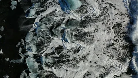 Ice rock with black sand beach at Jokulsarlon beach. Diamond beach in Iceland Stock Footage 133862701