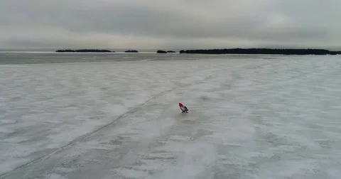 Ice sailing, Cinema 4k sideway aerial of a red ice yacht, on a cloudy day, .. Stock Footage 73959772