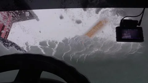 An ice scraper clears snow from the surface of a car. Medium shot. Video stock 313954586