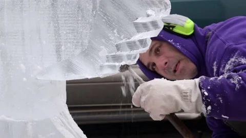 Ice sculptor cutting block of ice with chisel in Ononadga County, New York Stock Footage 147904083