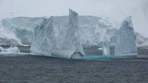 Ice sculptures floating iceberg formation Antarctica, 4K Stock Footage 332393648
