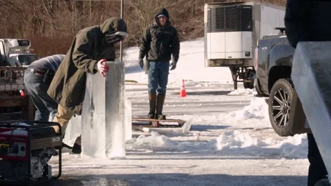 Ice sculptures moving blocks of Ice for ice carving competition in Maryland Stock Footage 147226595