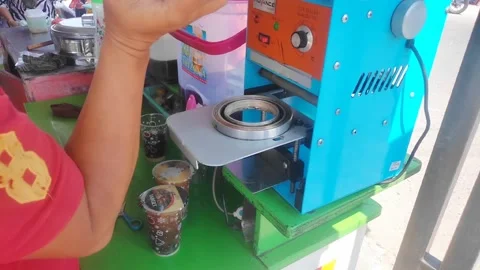 The ice seller seals several plastic cups Stock Footage 241709145
