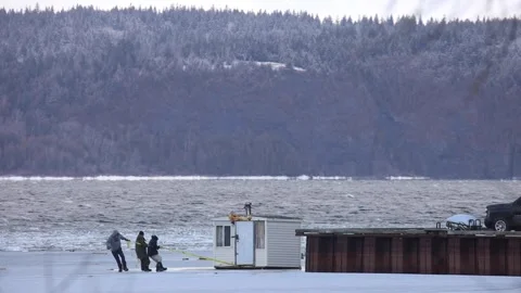 Ice Shack Sinks into River after Winter Storm Abruptly Ends Ice Fishing Season Stock Footage 266637735