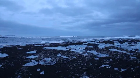 Ice shard crystal clear and waves Iceland glacier lagoon Jokulsarlon at dawn Stock Footage 72916331