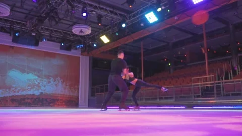 Ice skaters couple performs Layback spin figure skating element on ice rink Video stock 137466697