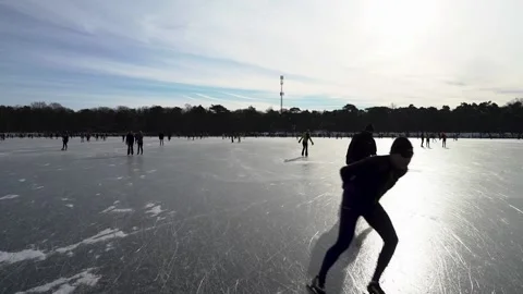 Ice skaters flying by sunlight Stock Footage 148629027