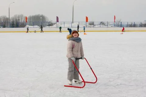 Ice skating with child support device Stock Photos