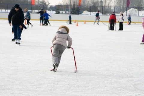 Ice skating with child support device Stock Photos