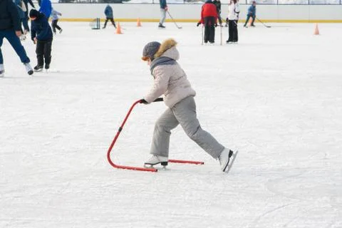 Ice skating with child support device Stock Photos