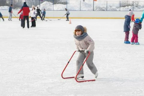Ice skating with child support device Stock Photos