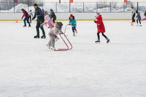 Ice skating with child support device Stock Photos