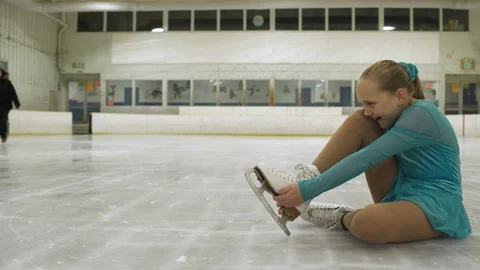 Ice skating coach helping young girl with ice skating injury. Stock Footage 88160406