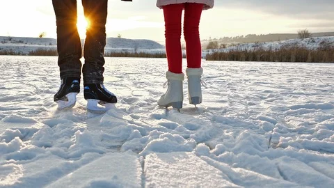 Ice skating on a lake against setting sun - slow motion Stock Footage 101314995