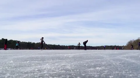 Ice skating on a lake low point Stock Footage 148629443