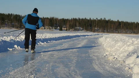 Ice skating. A man ice skating on a frozen lake Stock-Footage 102046210